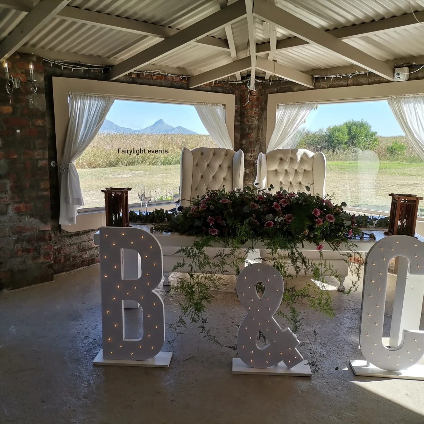 Light-up marquee letters and floral arrangement for a wedding